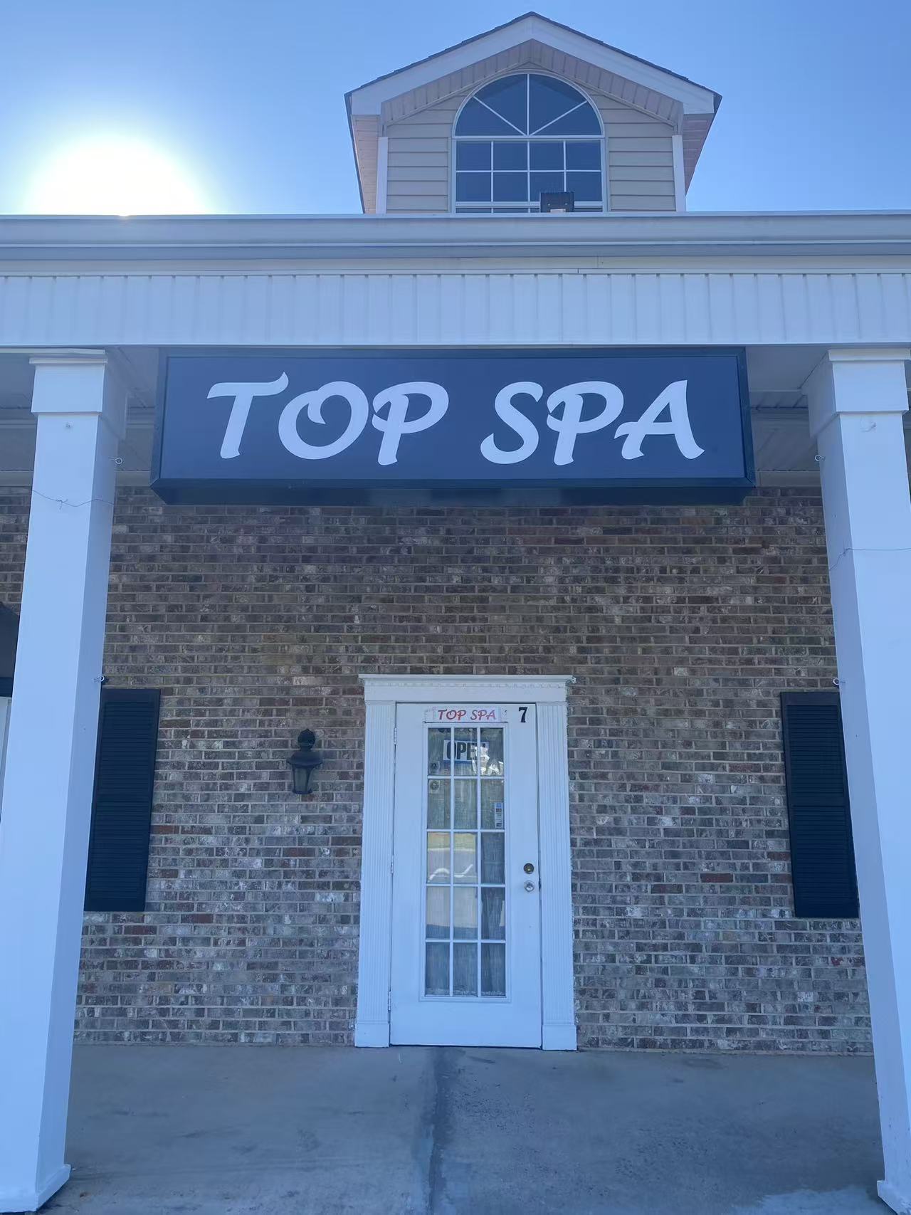 The Top Spa sign above our front door